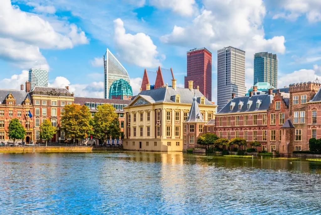 Historic buildings and modern skyscrapers reflected in the Hofvijver pond in The Hague.